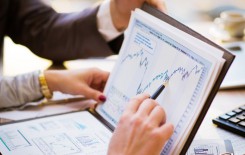 male hands pointing at business document
