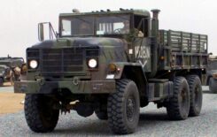 A US Marine Corps (USMC) M923 (6X6) 5-ton cargo truck heads a convoy departing Camp Matilda, Kuwait, after a desensitization exercise, during Operation ENDURING FREEDOM.